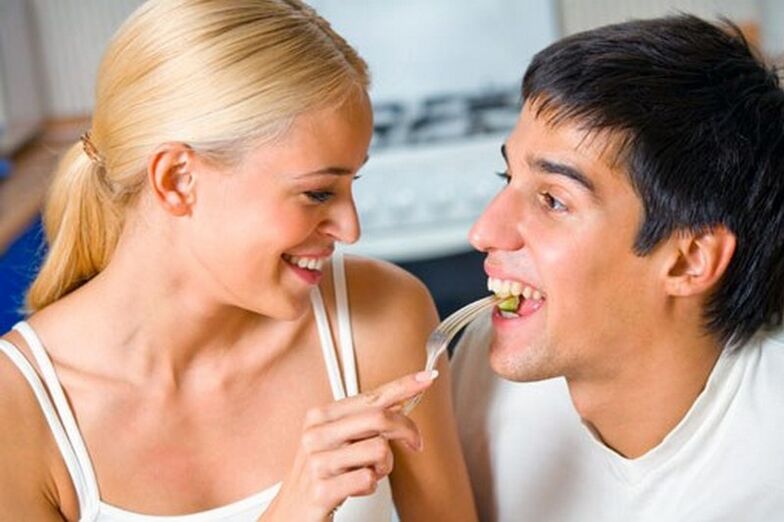 The woman feeds the man products to stimulate potency.